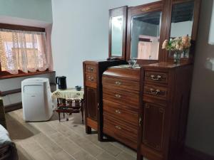 a bedroom with a large wooden dresser and a mirror at Casa Ludovica Trastevere in Rome