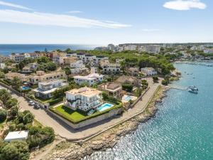 an aerial view of a city next to the water at NEW! Villa ESPERANZA, Can Marilla, Front Sea View, Pool, AC, BBQ in Portocolom