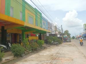 a group of buildings on the side of a street at BOTANIA HOMESTAY BATAM in Nongsa