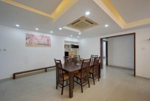 a dining room with a table and chairs at BayView Retreat Premium Stay at Marine Drive Kochi in Cochin
