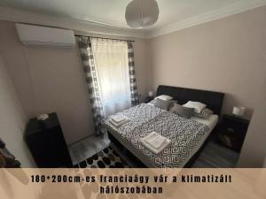 a bedroom with a bed and a window at Estina House in Balatonboglár +16 photos