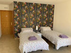 Postel nebo postele na pokoji v ubytování Hostal Casa Michaels