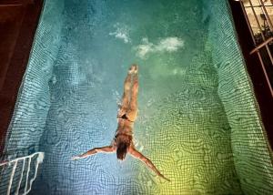 a person floating in a pool of water at MuchoSur Santa Marta in Santa Marta