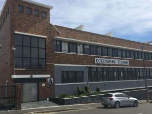 a car parked in front of a brick building at 105 Queens Park in Cape Town