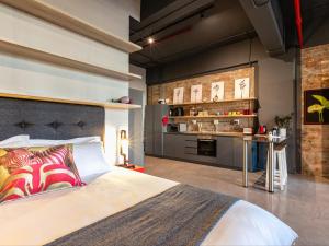 a bedroom with a bed and a table in a room at 105 Queens Park in Cape Town