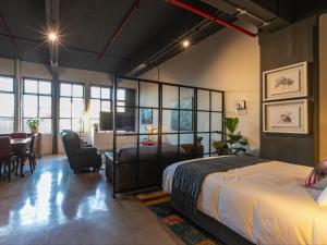 a bedroom with a bed and a table and chairs at 105 Queens Park in Cape Town