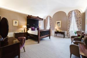 a large room with a bed and chairs in it at Winchester Royal Hotel in Winchester +55 photos