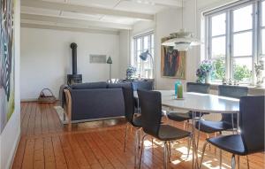a living room with a table and chairs and a couch at 3 Bedroom Gorgeous Home In Allinge in Allinge