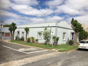 a white building on the side of a street at The Pink Door in Caledon