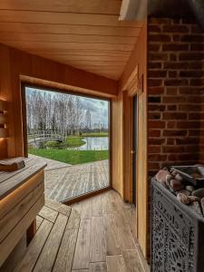 a room with a large sliding glass door to a patio at Dabas Osta in Jūdaži +114 photos