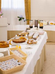 a long white table with food on it at Centro Paolo VI in Brescia