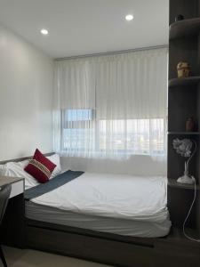 a bedroom with a large bed with a window at Tom homestay, căn hộ Nera garden Huế in Hue