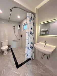 a bathroom with a sink and a toilet at Baan Boon in Bangkok +42 photos