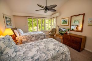 een slaapkamer met twee bedden en een plafondventilator bij Elua 704 in Wailea +78 foto's