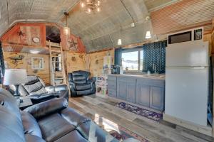 a kitchen and living room in a tiny house at Steamboat Rock Cabin Near Trails and River! in Steamboat Rock
