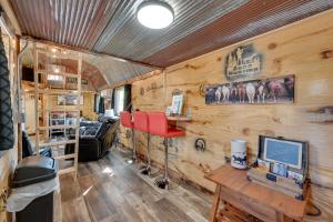 a living room in a trailer with wooden walls at Steamboat Rock Cabin Near Trails and River! in Steamboat Rock