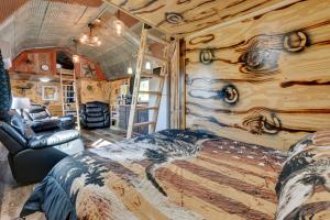 a bedroom with a bed and a chair in a room at Steamboat Rock Cabin Near Trails and River! in Steamboat Rock