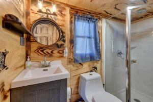 a bathroom with a toilet and a sink and a shower at Steamboat Rock Cabin Near Trails and River! in Steamboat Rock +18 photos