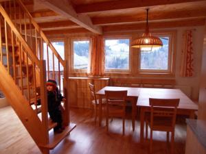 a little boy sitting at a dining room table in a cabin at Laberer by Schladmingurlaub in Schladming