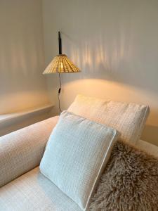 a lamp sitting on top of a bed at Maison Olive in Torhout