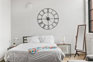 a bedroom with a large clock on the wall at 310-Cozy DT Haven Cafe Wi-Fi Parking in Cleveland