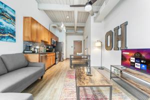a living room with a couch and a table at 310-Cozy DT Haven Cafe Wi-Fi Parking in Cleveland