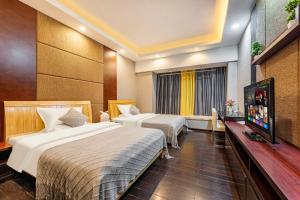 Ένα ή περισσότερα κρεβάτια σε δωμάτιο στο 广州家馨商务住宿（科汇金谷神州路地铁站店） +12 φωτογραφίες