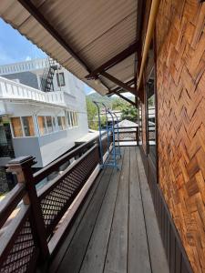 a wooden deck with awning on a building at HAYO Villa and Guesthouse in Haurkuning