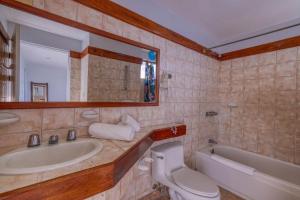 a bathroom with a sink and a toilet and a tub at Ocean and Mountain View Villa in Playa Hermosa +37 photos