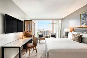 a hotel room with a bed and a desk and a television at Omni Tempe Hotel at ASU in Tempe +58 photos