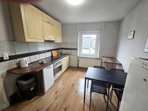 a small kitchen with a table and a counter top at Workers Apartments Satzvey in Satzvey +46 photos