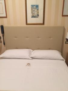 Postel nebo postele na pokoji v ubytování Hotel Ariella