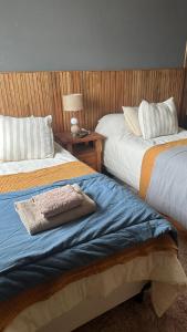 two beds sitting next to each other in a bedroom at Hospedaje "Room" in El Chalten