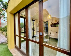a glass door to a room with a living room at Residenza Serra in Villasimius