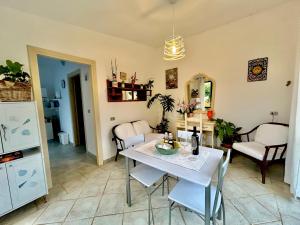 a living room with a white table and chairs at Residenza Serra in Villasimius