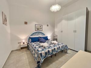 a bedroom with a blue and white bed and a table at Residenza Serra in Villasimius +74 photos