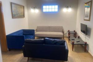 a living room with two blue couches and a tv at Magnificent Beach side home with WiFi Jerry`s condo #1 in San Felipe
