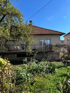 a house with a porch and a balcony at Kuća marinković in Vlasenica