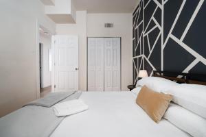 ein Schlafzimmer mit zwei weißen Betten und einer schwarz-weißen Wand in der Unterkunft Ukrainian Village 2BR Modern Apartment D2 in Chicago + 21 Fotos