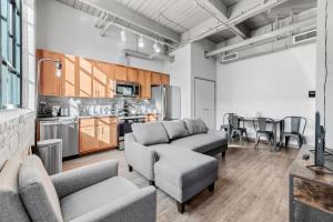 a living room with two couches and a kitchen at 320- Downtown Loft Luxe Mattress Prking FAST Wifi in Cleveland
