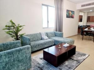 a living room with a couch and a coffee table at Aspire Tower # 10th Floor Aspire Tower Paradise in Manama