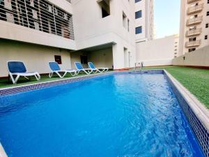 a swimming pool in the middle of a building at Aspire Tower - Two Bedroom Sunny Staycation in Manama