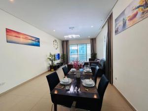 a dining room with a table and some chairs at Aspire Tower - Two Bedroom Sunny Staycation in Manama