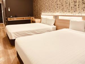 Postel nebo postele na pokoji v ubytování Kansai International Airport Hotel 11