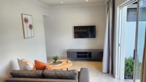 a living room with a couch and a table at Executive Suites Brackenhurst in Alberton