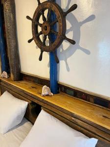 a wooden shelf with a steering wheel on a wall at Cabana Didi in Cruz