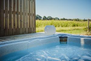 a cup of coffee sitting in a hot tub at Ô NaNo Glamping in Dalhem