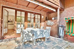a dining room with a table and chairs on a patio at Ferienhaus Ostseeferien bei Bella Appartement 1 in Schürsdorf
