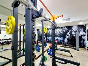a gym with a bunch of weight machines at Aspire Tower # Serenity Suite Juffair in Manama