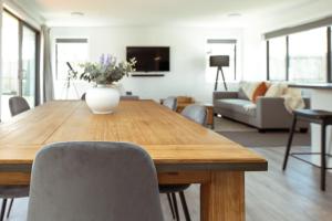 a dining room table with chairs and a vase of flowers at Family Friendly on Forest Drive in Methven